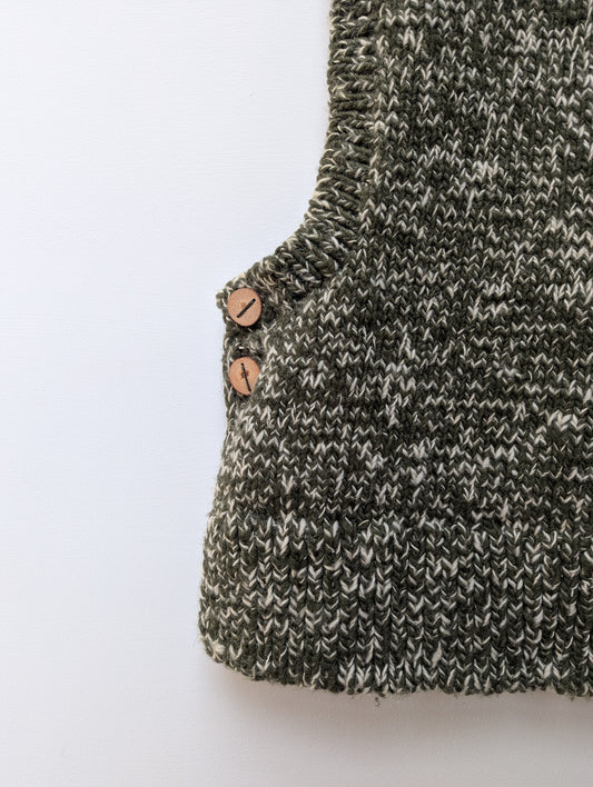 High neck handloom wool knit vest for men and women in forest green lower left view
