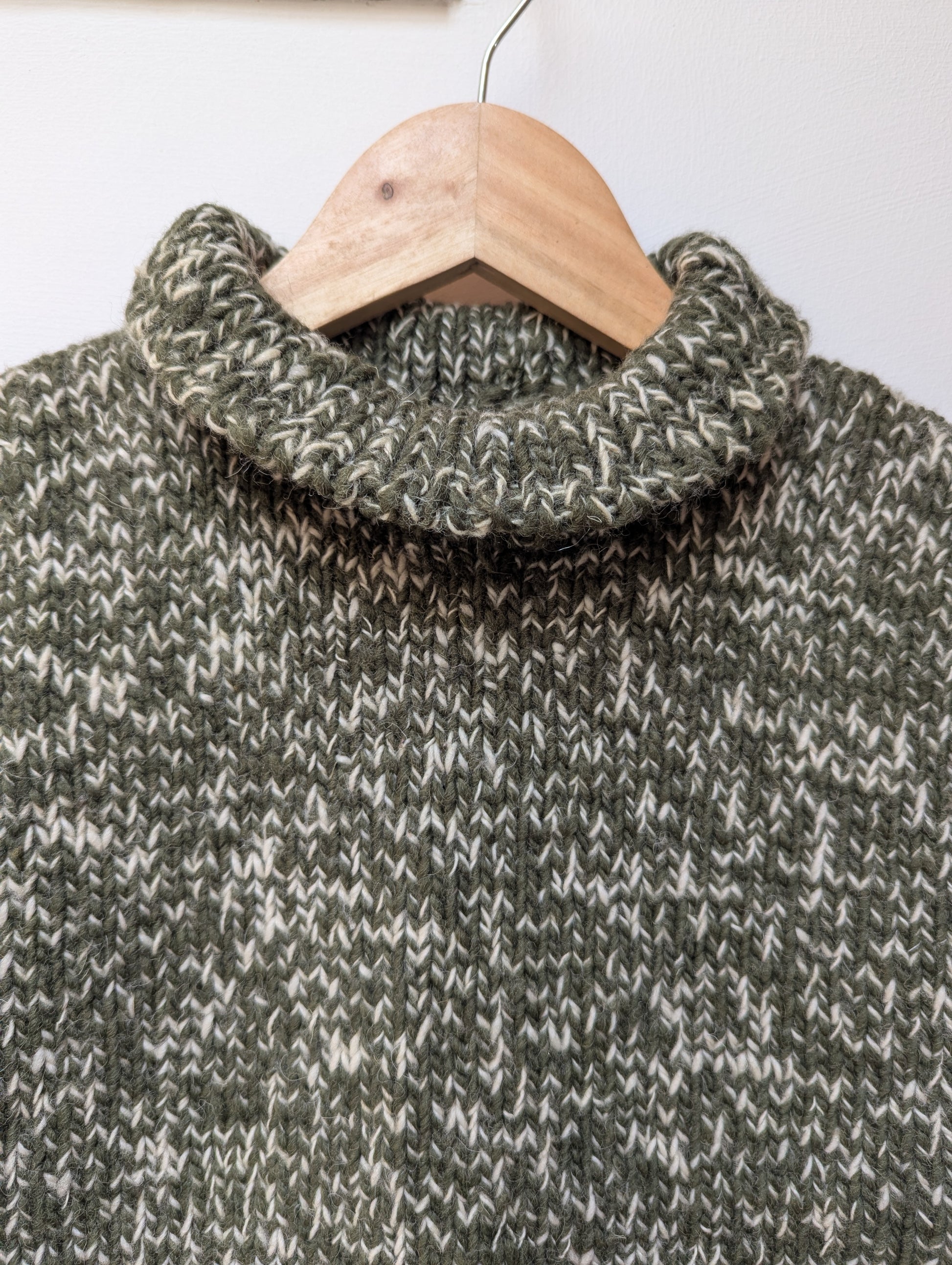 High neck handloom wool knit vest for men and women in forest green upper view