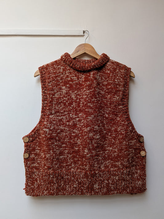 High neck handloom wool knit vest for men and women in rust orange front view