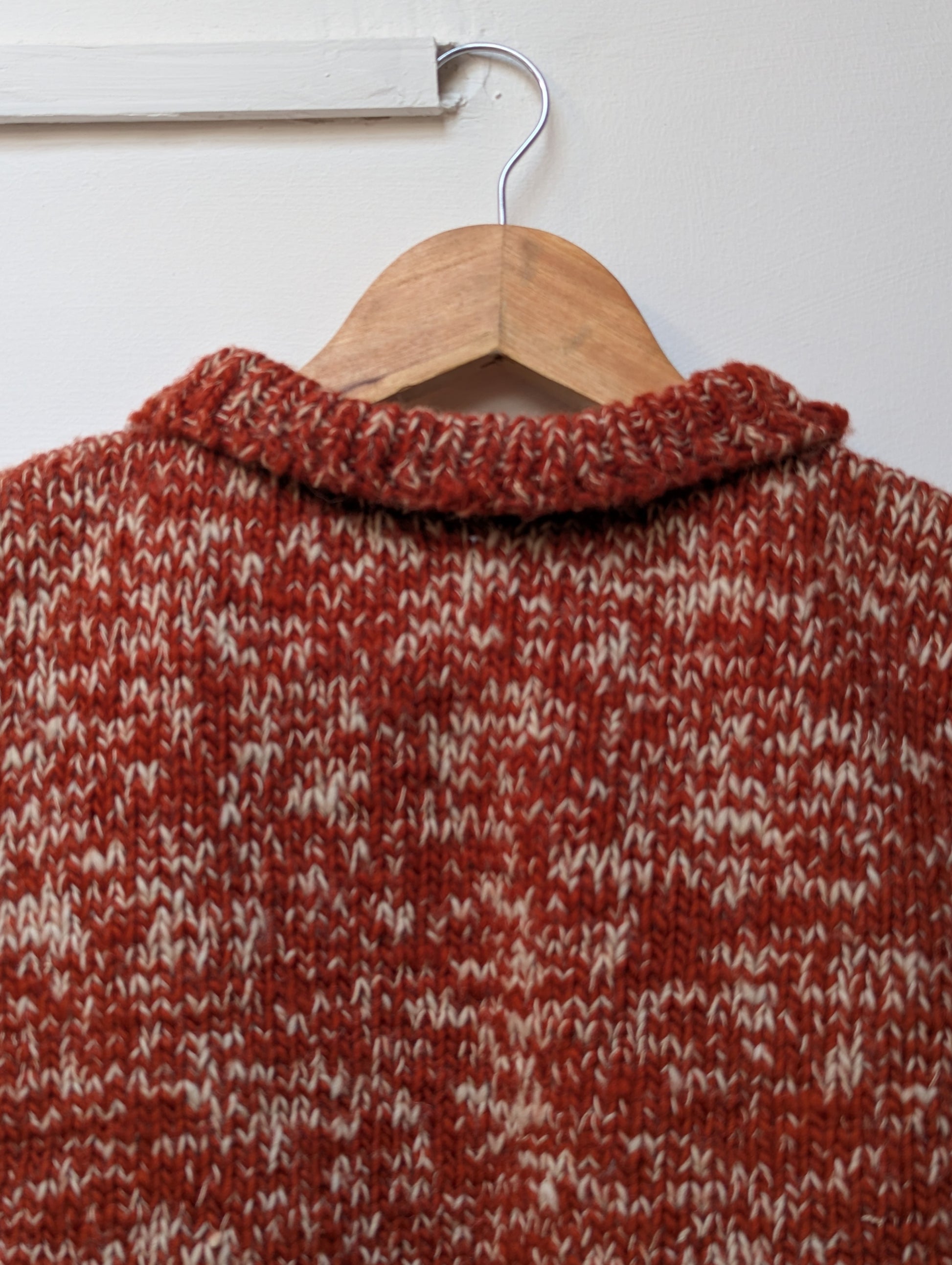 High neck handloom wool knit vest for men and women in rust orange upper view