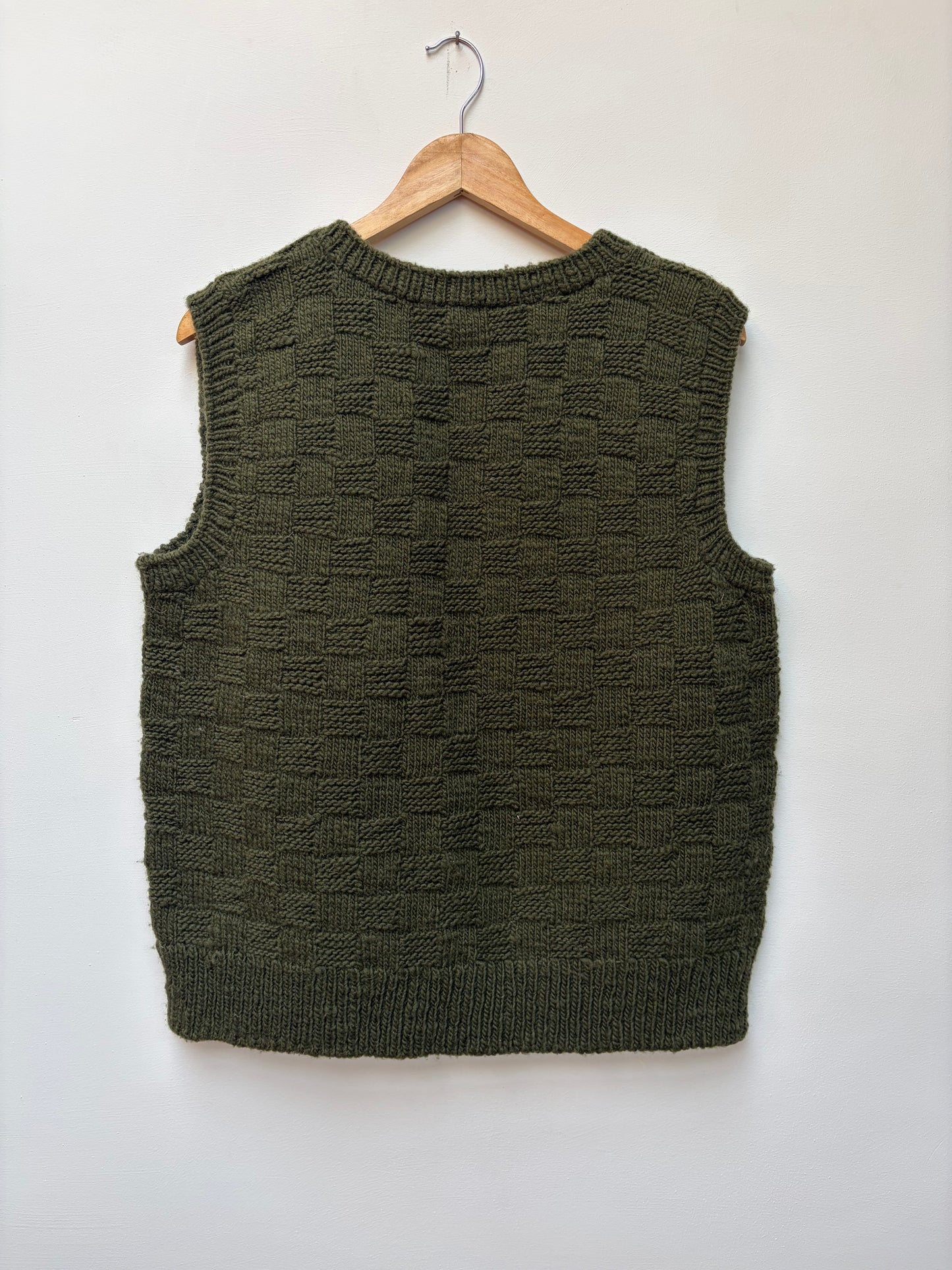 Textured handloom wool knit vest for men and women in olive green back view 