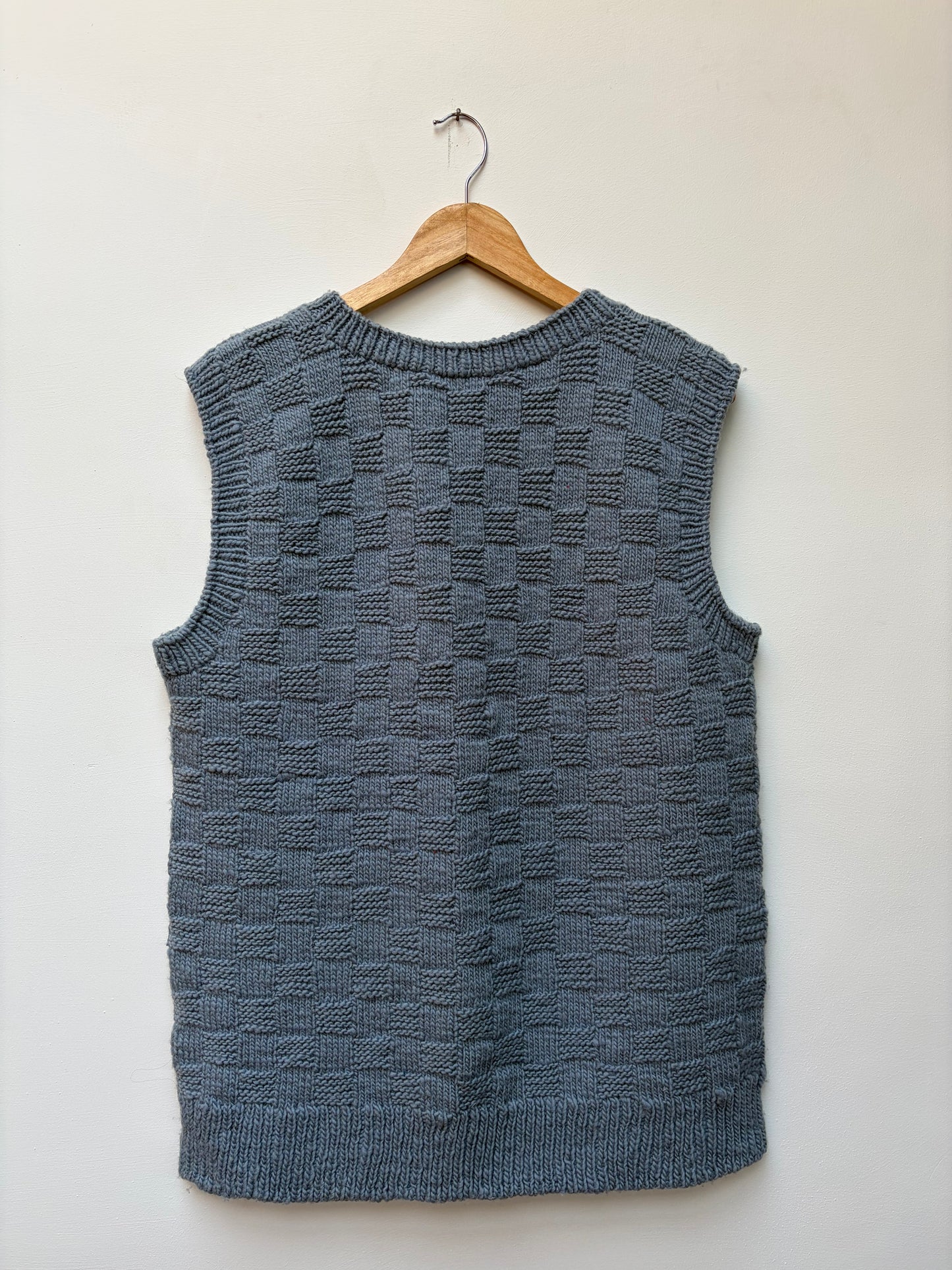 Textured handloom wool knit vest for men and women in steel blue back view 